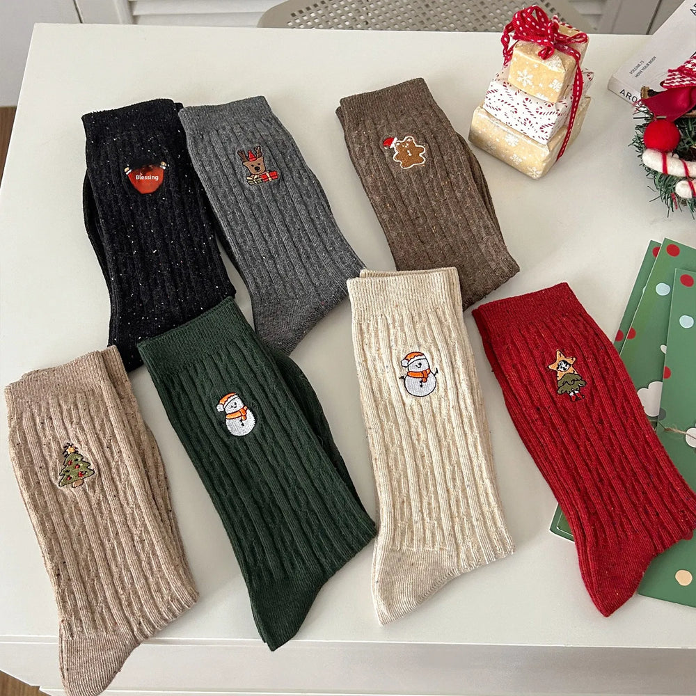 Close-up detail of a warm cable knit socks for women with an embroidered snowman