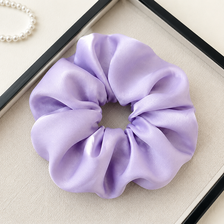 Satin hair scrunchie with a wide soft band - held in hand for scale